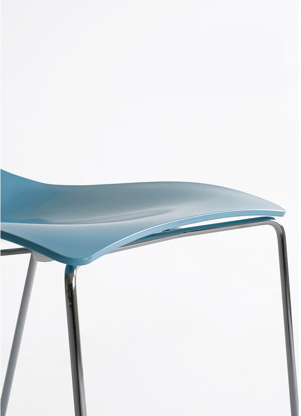 A close-up of a modern chair featuring a glossy light blue molded plastic seat and slim chrome metal legs, set against a plain white background.
