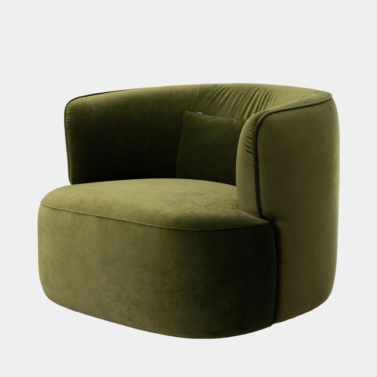 Front three-quarter view of a contemporary olive green velvet lounge chair featuring a rounded barrel silhouette, curved wraparound backrest, integrated armrests, deep cushioned seat and matching scatter cushion.
