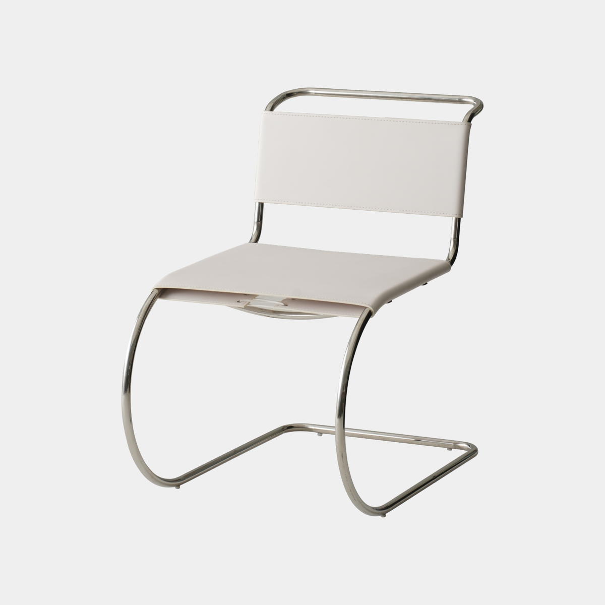 A modern cantilever chair with a light beige upholstered seat and backrest, supported by a curved polished chrome metal frame, shown against a plain light gray background.