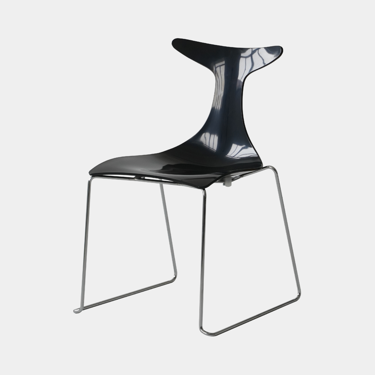A modern black molded plastic chair with a curved, sculptural backrest and a thin silver metal wire frame, shown against a light gray background.